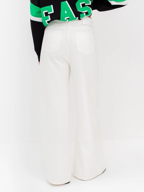 Джинсы из 100% хлопка расширенные к низу